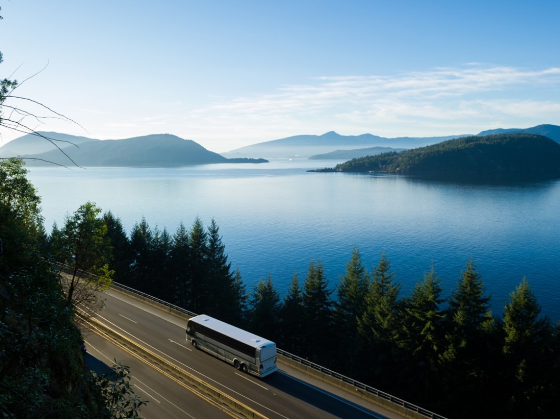Bus driving near a body of water