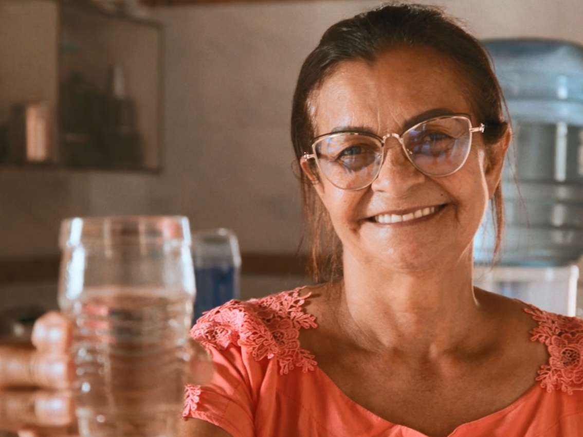 woman holding clean glass of water
