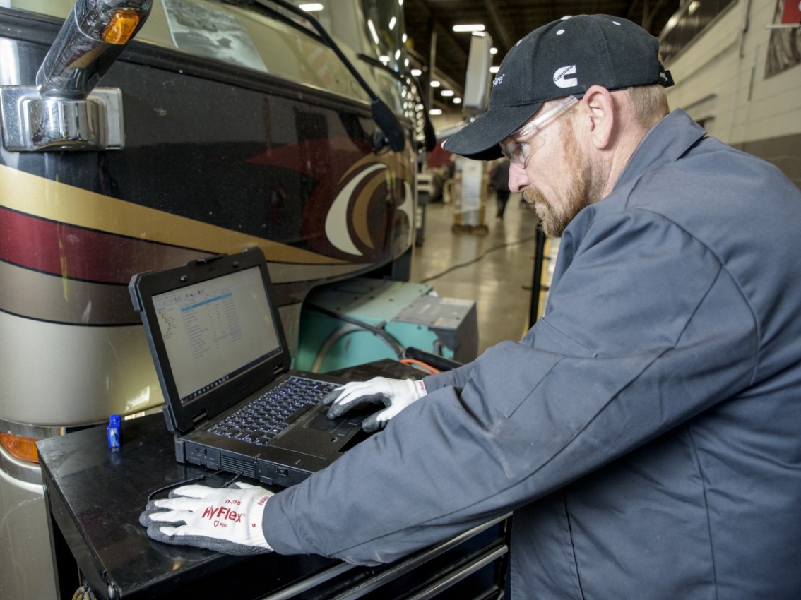 Cummins PowerSpec being used on a laptop beside a vehicle