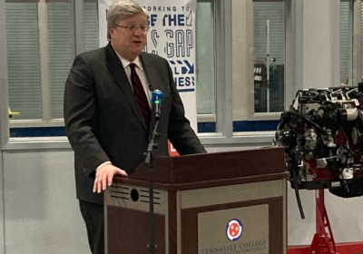 Speaker behind a podium